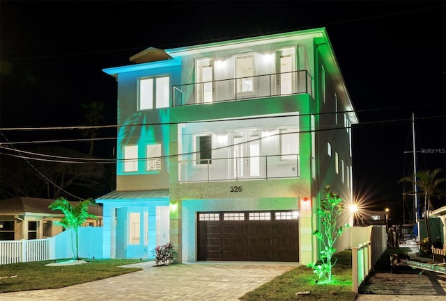 view of front of property with a balcony and a garage