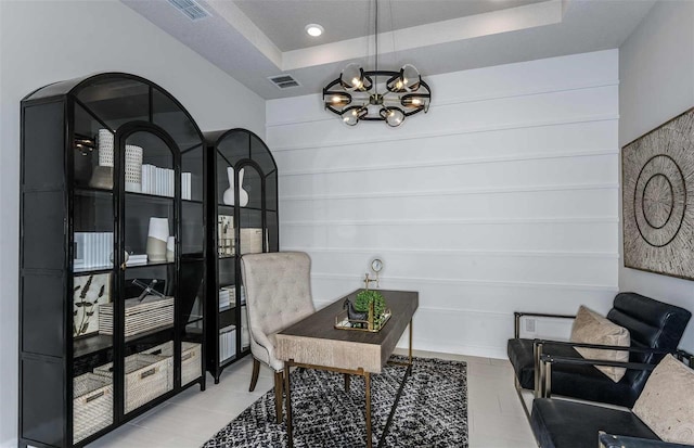 office with a raised ceiling, a textured ceiling, and an inviting chandelier