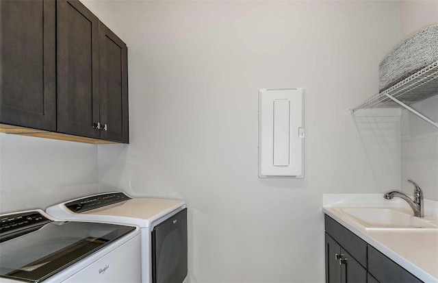 clothes washing area with electric panel, sink, cabinets, and independent washer and dryer