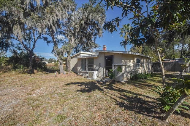 back of house with ac unit