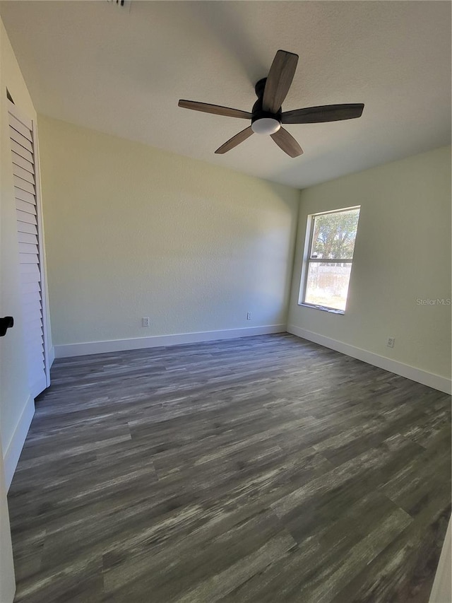 unfurnished room with ceiling fan and dark hardwood / wood-style floors