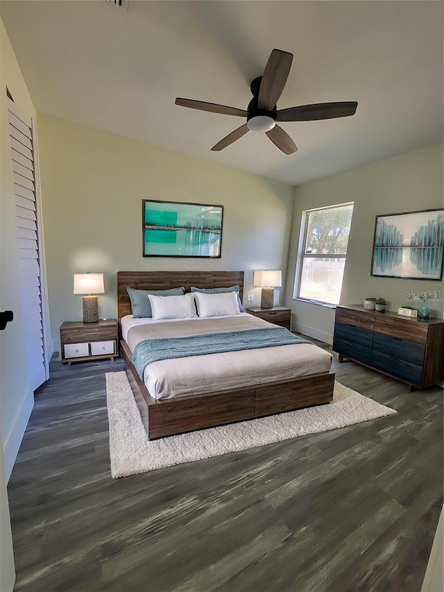 bedroom with ceiling fan and dark hardwood / wood-style flooring