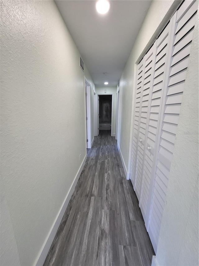 corridor featuring dark hardwood / wood-style flooring