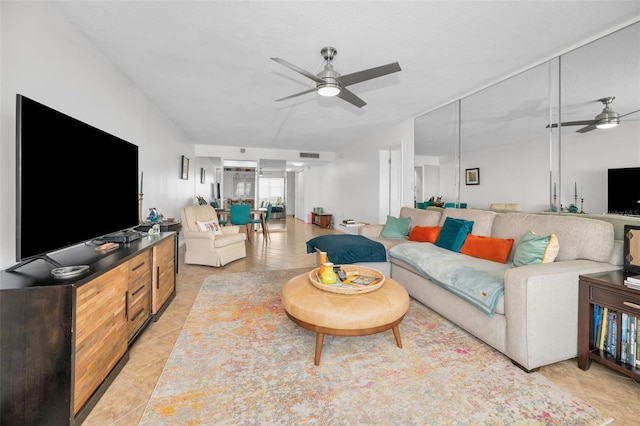 living room featuring ceiling fan and light tile patterned flooring