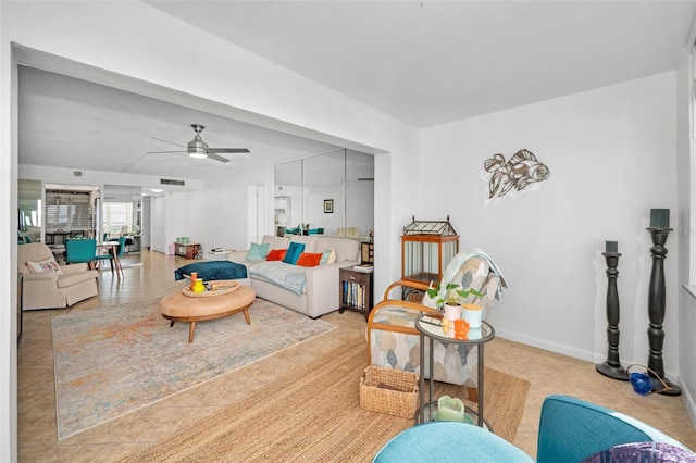 living room with ceiling fan and light tile patterned floors