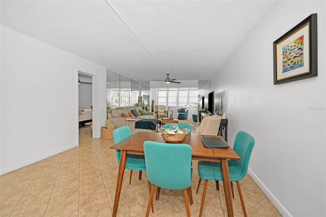 dining room with ceiling fan and light tile patterned flooring