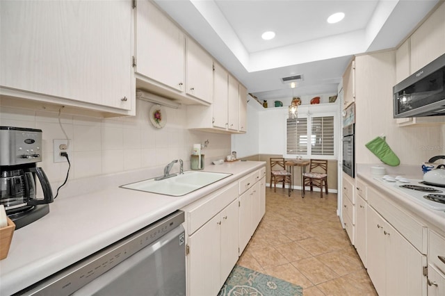 kitchen featuring sink, light tile patterned floors, decorative light fixtures, white cabinetry, and stainless steel appliances