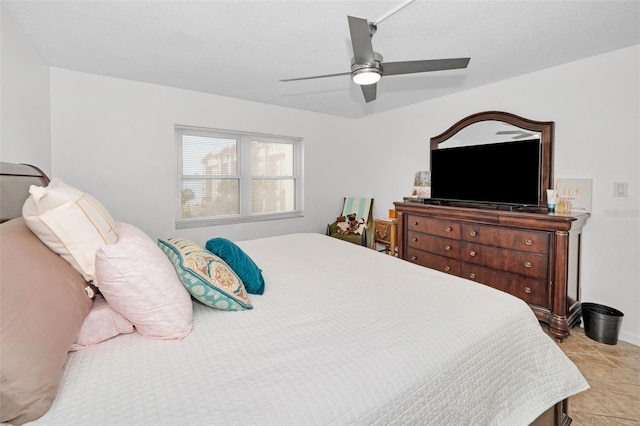 bedroom with ceiling fan and light tile patterned floors