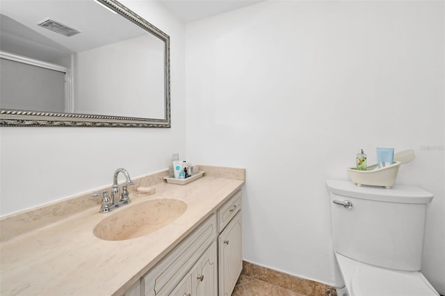 bathroom with tile patterned floors, vanity, and toilet