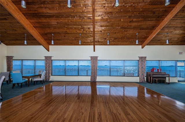 interior space featuring dark hardwood / wood-style flooring, beamed ceiling, and high vaulted ceiling