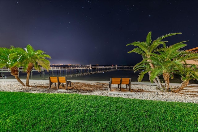 view of community featuring a lawn and a water view