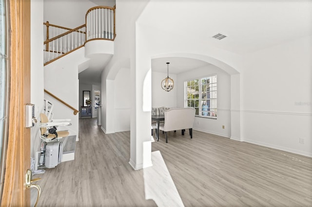 entrance foyer featuring light hardwood / wood-style floors and a chandelier