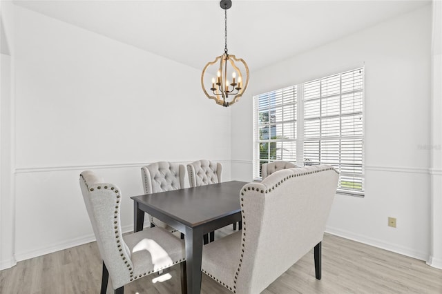 dining room with an inviting chandelier and light hardwood / wood-style flooring