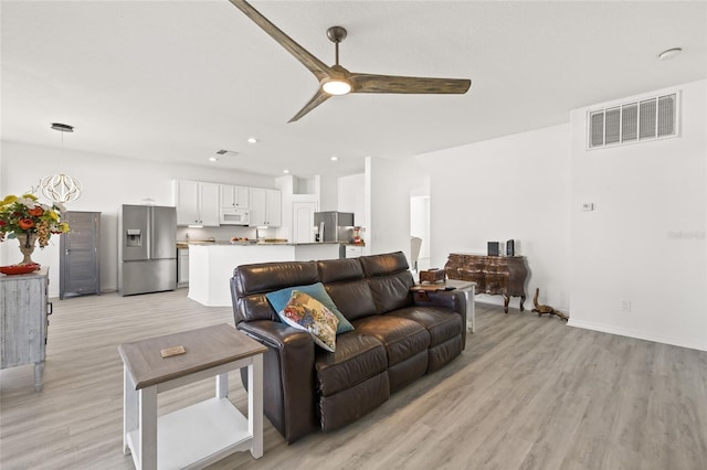 living room with ceiling fan and light wood-type flooring