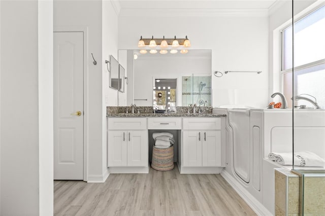 bathroom with crown molding, a shower with door, vanity, and hardwood / wood-style flooring