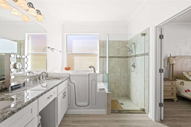 bathroom featuring wood-type flooring, a shower with shower door, and ornamental molding