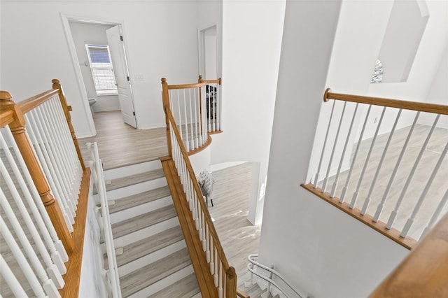 staircase with hardwood / wood-style floors