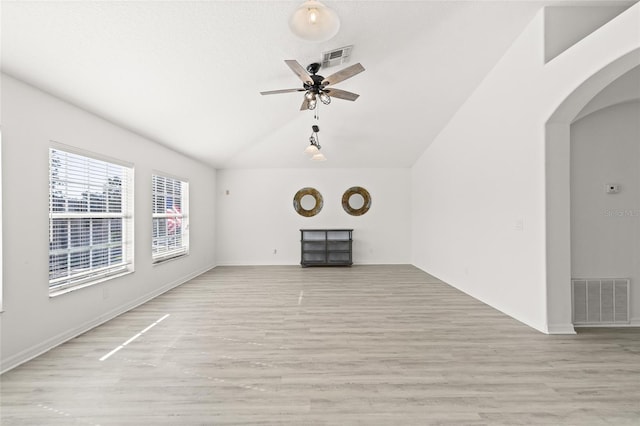 unfurnished living room with ceiling fan, light hardwood / wood-style floors, and lofted ceiling