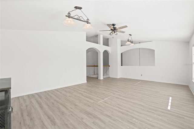 unfurnished living room with ceiling fan, high vaulted ceiling, and light wood-type flooring