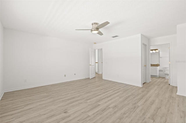 unfurnished bedroom featuring ceiling fan, light hardwood / wood-style floors, and ensuite bath