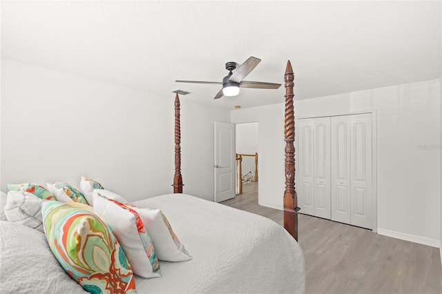 bedroom featuring ceiling fan, a closet, and light hardwood / wood-style floors