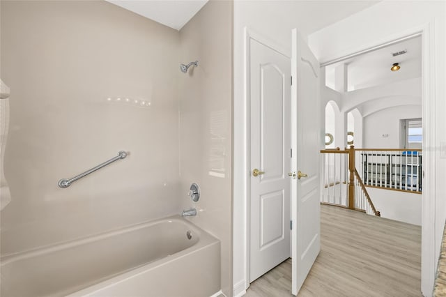 bathroom with shower / bath combination and wood-type flooring