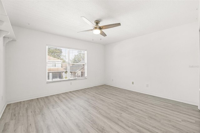 unfurnished room featuring ceiling fan, a textured ceiling, and light hardwood / wood-style flooring