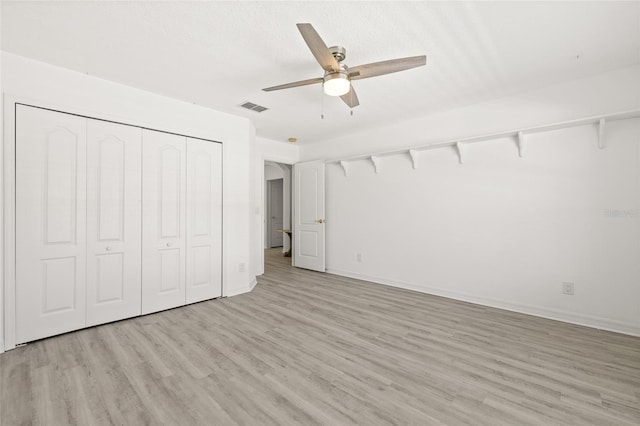 unfurnished bedroom with ceiling fan, a closet, and light hardwood / wood-style flooring