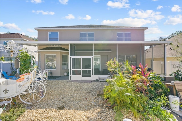 rear view of property with a sunroom