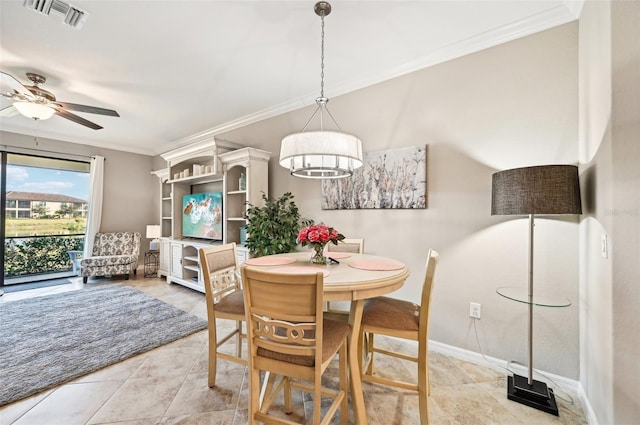 dining space with crown molding and ceiling fan