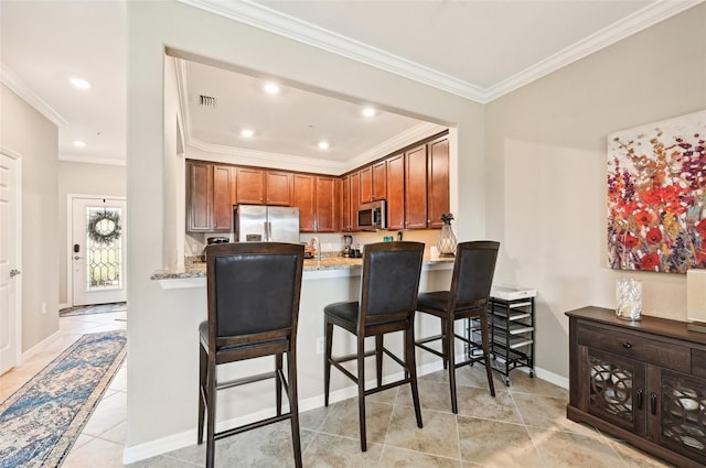 kitchen with kitchen peninsula, a kitchen breakfast bar, light stone counters, stainless steel appliances, and crown molding