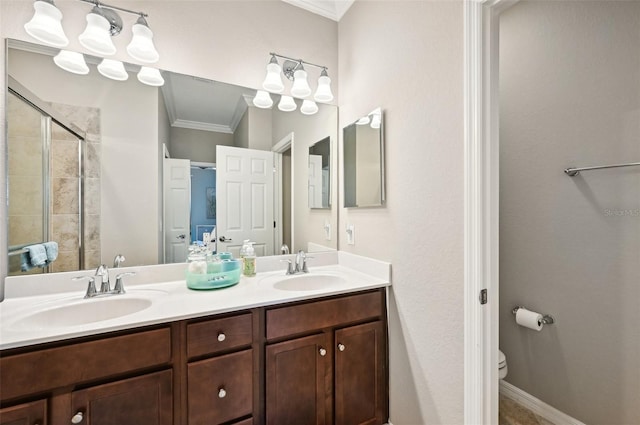 bathroom with crown molding, vanity, an enclosed shower, and toilet