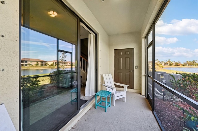 unfurnished sunroom with a water view