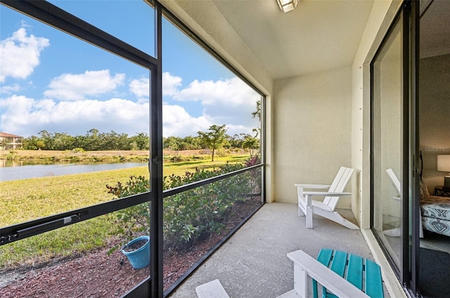 unfurnished sunroom with a water view