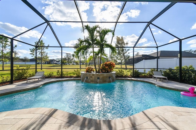 view of swimming pool featuring pool water feature, a patio, and a lanai