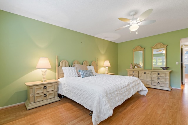 bedroom with ceiling fan and light hardwood / wood-style floors