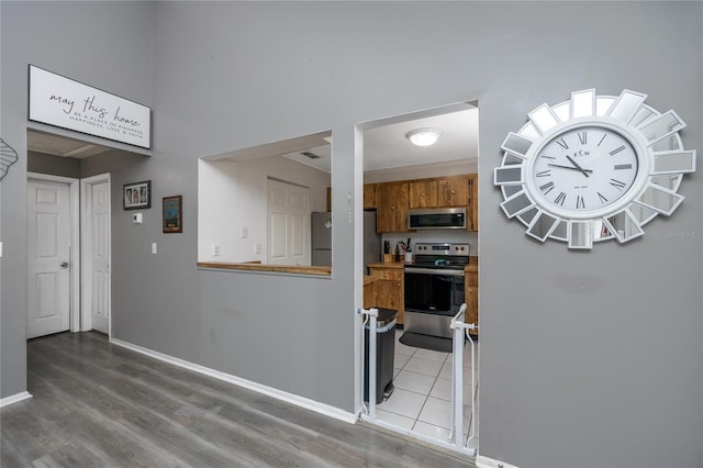 kitchen featuring hardwood / wood-style floors and appliances with stainless steel finishes