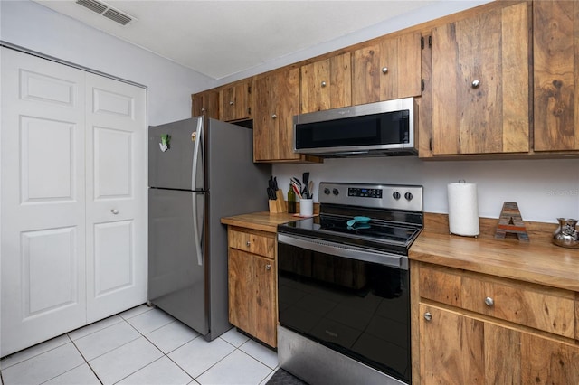 kitchen featuring appliances with stainless steel finishes and light tile patterned floors