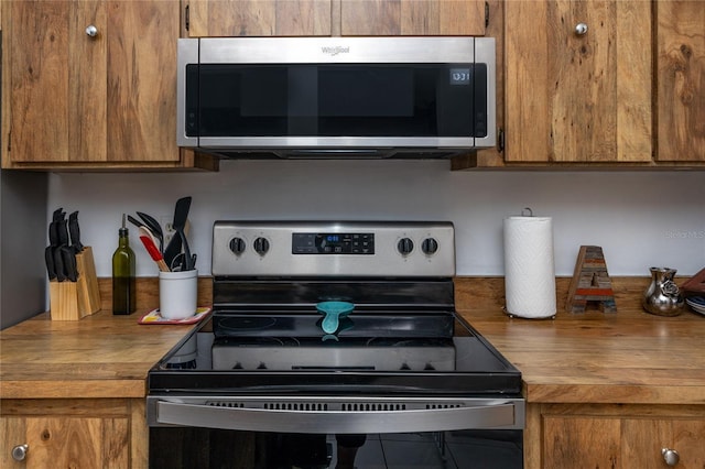 kitchen featuring butcher block counters and appliances with stainless steel finishes