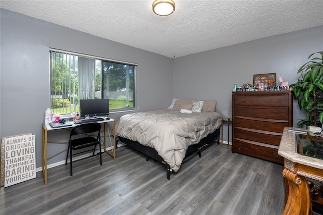 bedroom with hardwood / wood-style floors and a textured ceiling