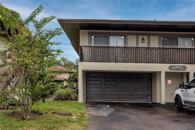 view of front of home featuring a balcony and a garage