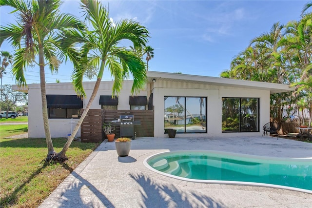 view of swimming pool featuring area for grilling and a patio