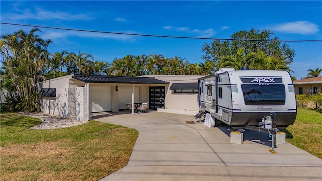 view of front of house with a carport and a front lawn