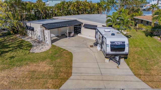 view of front facade with a front yard and a carport