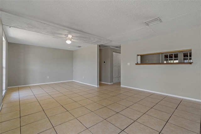 tiled spare room featuring ceiling fan and a textured ceiling