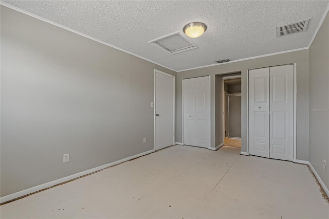 unfurnished bedroom featuring crown molding and a textured ceiling