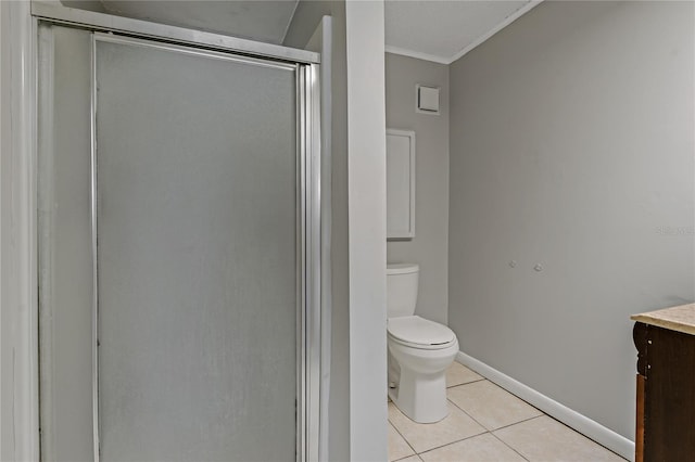 bathroom with tile patterned flooring, vanity, ornamental molding, toilet, and walk in shower