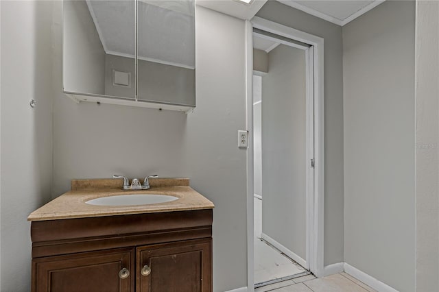 bathroom featuring tile patterned flooring, vanity, and ornamental molding