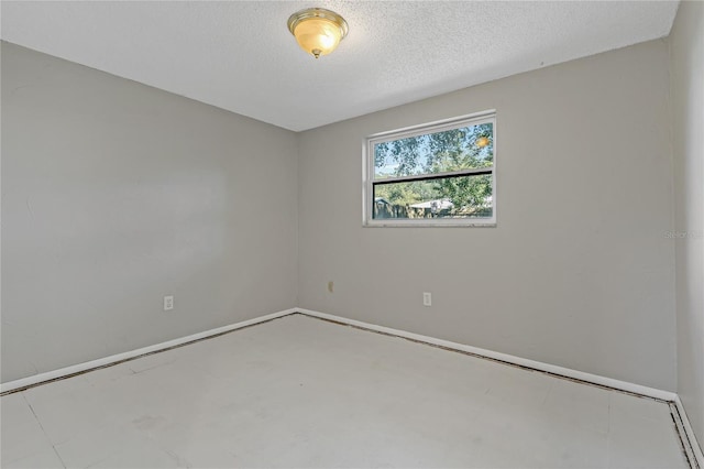 spare room with a textured ceiling