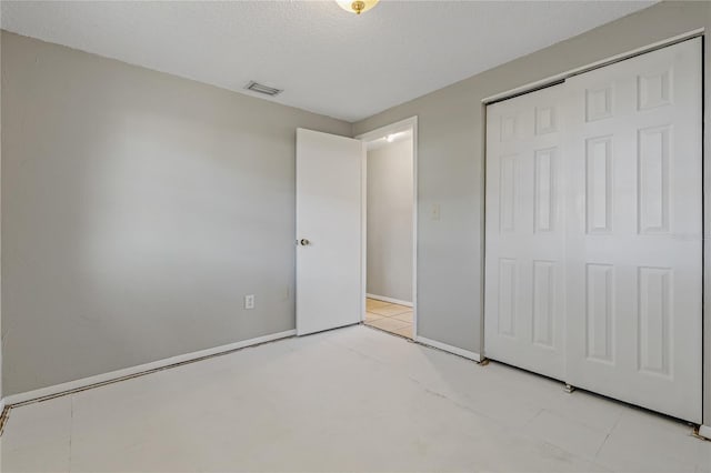 unfurnished bedroom featuring a closet and a textured ceiling